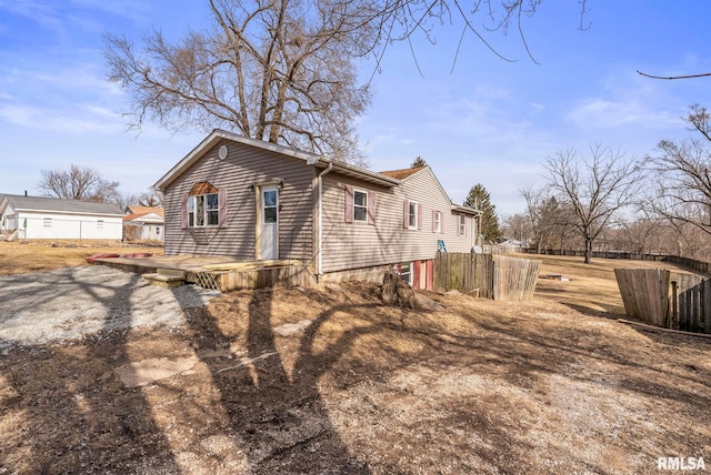 view of property exterior with fence