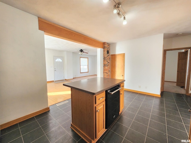 kitchen featuring a kitchen island, rail lighting, dishwasher, dark tile patterned flooring, and ceiling fan