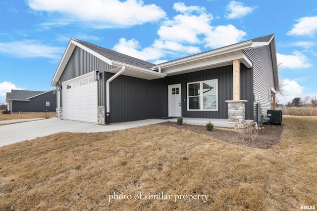 ranch-style home featuring a garage, a front yard, and a porch