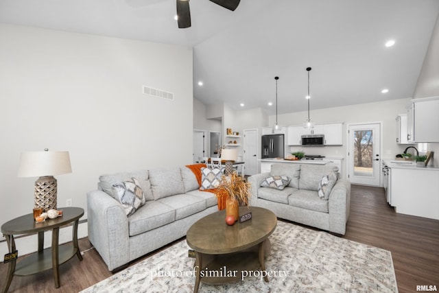 living room with sink, high vaulted ceiling, dark hardwood / wood-style floors, and ceiling fan