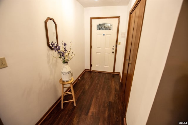 hallway with dark hardwood / wood-style floors