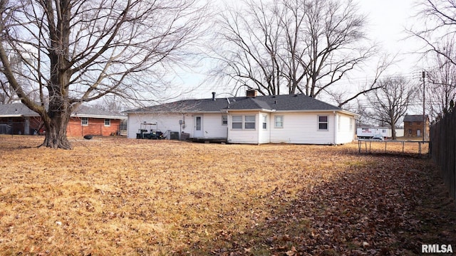 back of house featuring a trampoline