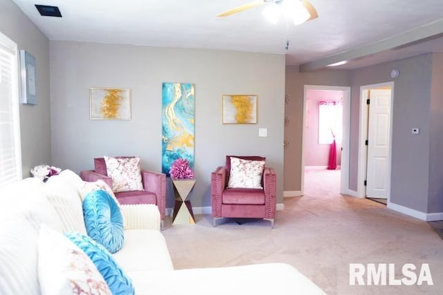 carpeted living room featuring ceiling fan