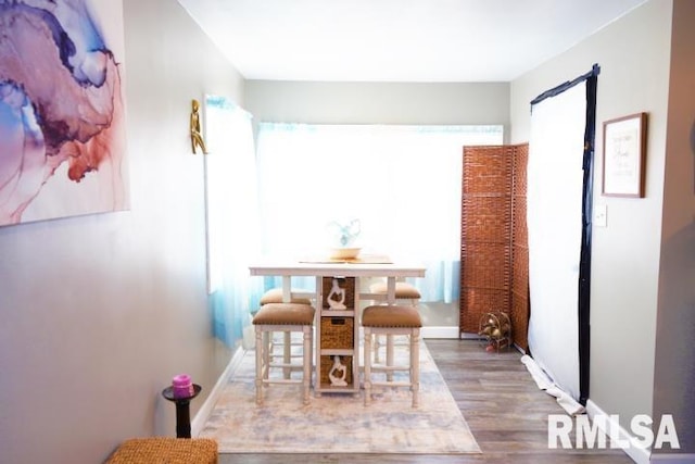 dining space with hardwood / wood-style flooring and plenty of natural light