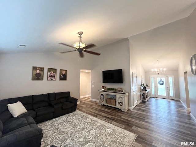 living room featuring lofted ceiling, ceiling fan with notable chandelier, and dark hardwood / wood-style flooring