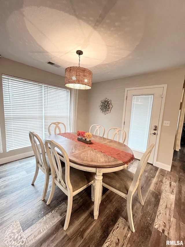 dining space featuring dark wood-type flooring