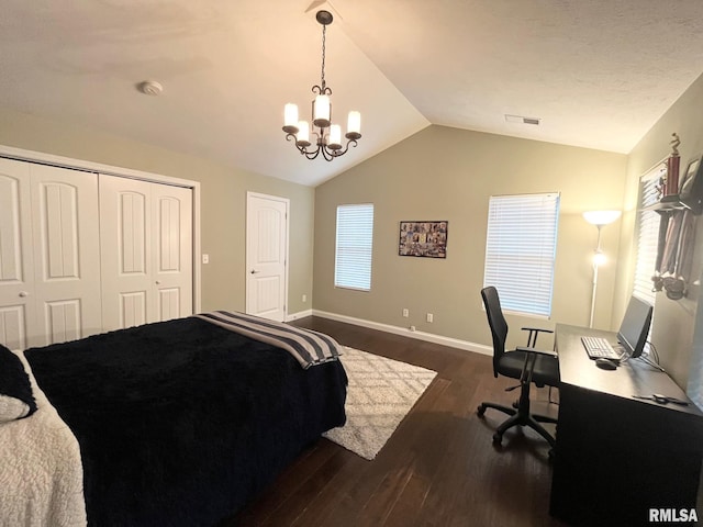 bedroom with an inviting chandelier, lofted ceiling, dark hardwood / wood-style flooring, and a closet