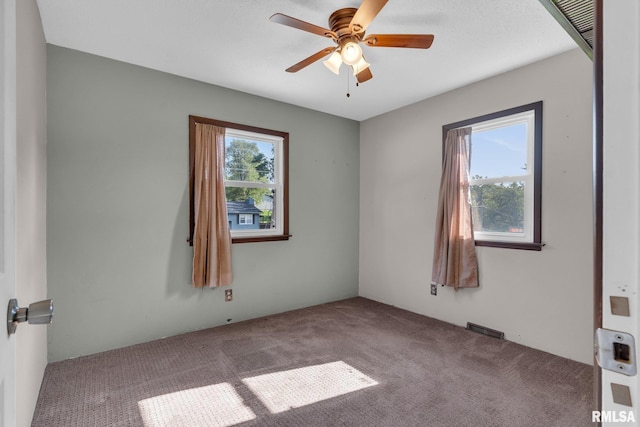 unfurnished room featuring carpet floors and ceiling fan