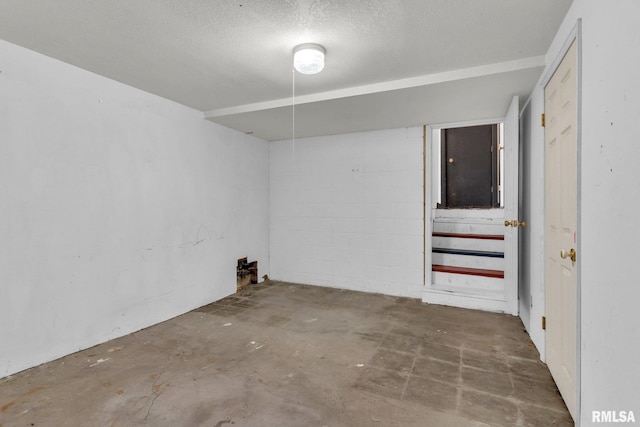 interior space with concrete flooring and a textured ceiling