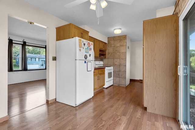 kitchen with ceiling fan, white appliances, and light hardwood / wood-style flooring