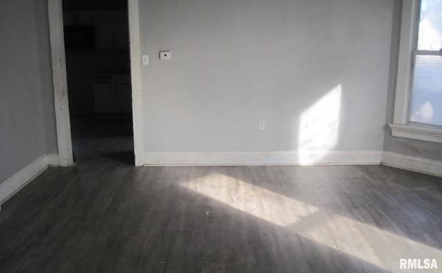 unfurnished room with dark hardwood / wood-style flooring