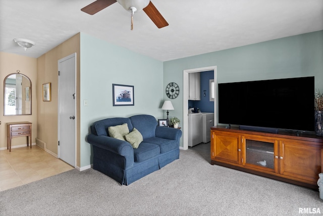 carpeted living room with ceiling fan and washer and clothes dryer