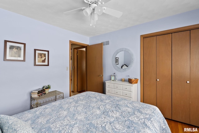 bedroom with ceiling fan, a closet, and light wood-type flooring