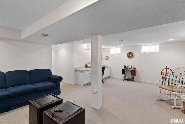 living room featuring light colored carpet and a textured ceiling