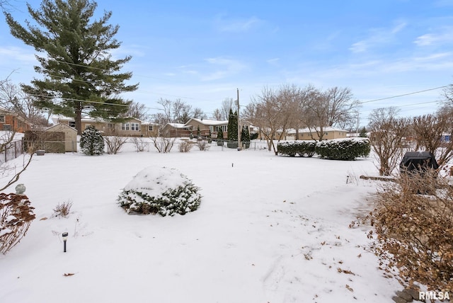 view of yard layered in snow