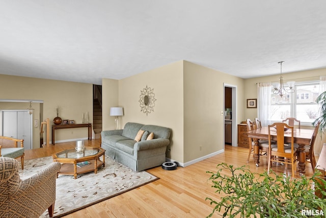 living room featuring an inviting chandelier and light hardwood / wood-style floors