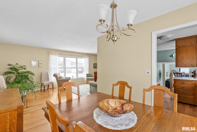 dining room featuring light hardwood / wood-style flooring and a notable chandelier