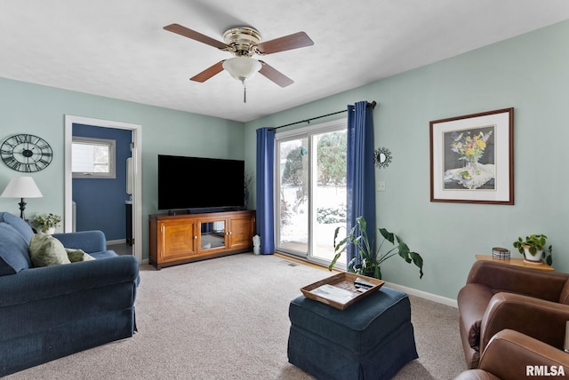 carpeted living room with ceiling fan