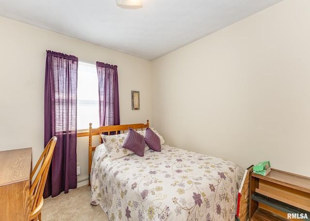 bedroom featuring light colored carpet