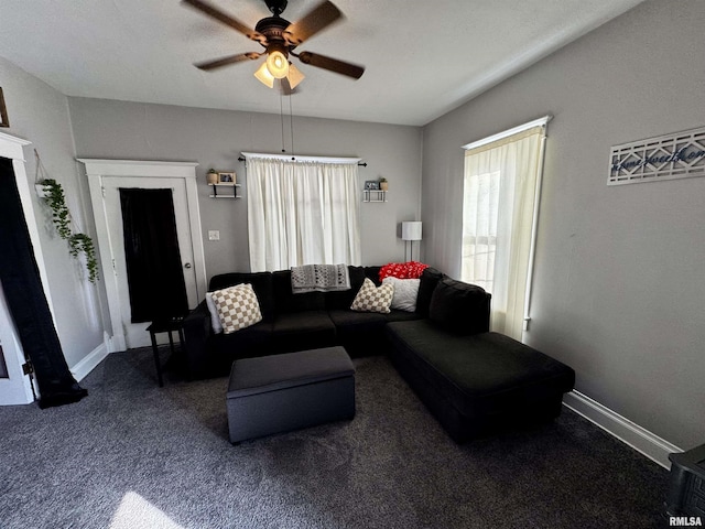 living room featuring dark carpet and ceiling fan