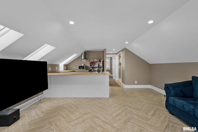 additional living space with vaulted ceiling with skylight and light parquet flooring