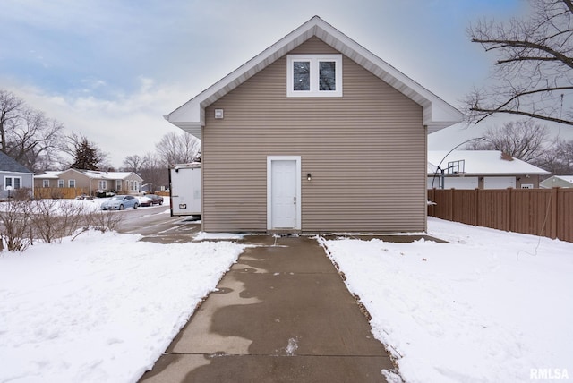 view of snow covered rear of property