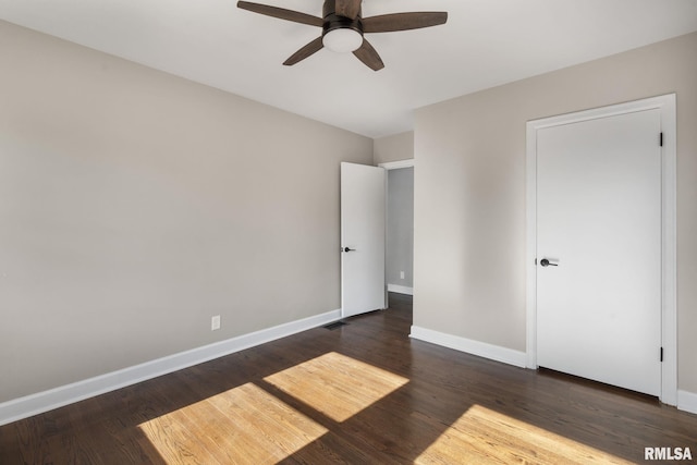 unfurnished bedroom with dark hardwood / wood-style floors and ceiling fan