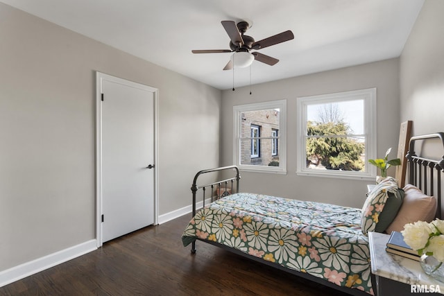 bedroom with dark hardwood / wood-style floors and ceiling fan