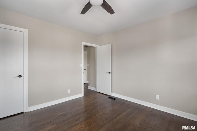 spare room with dark hardwood / wood-style floors and ceiling fan