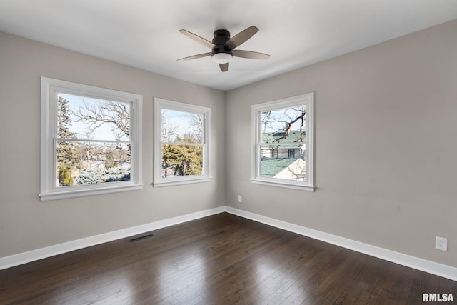 unfurnished room with dark wood-type flooring and ceiling fan