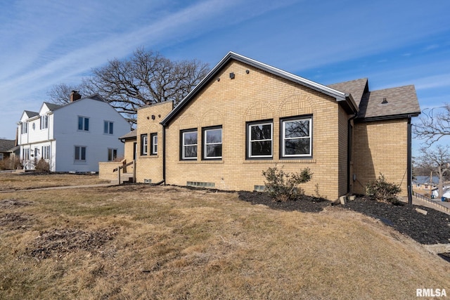 rear view of property with a yard