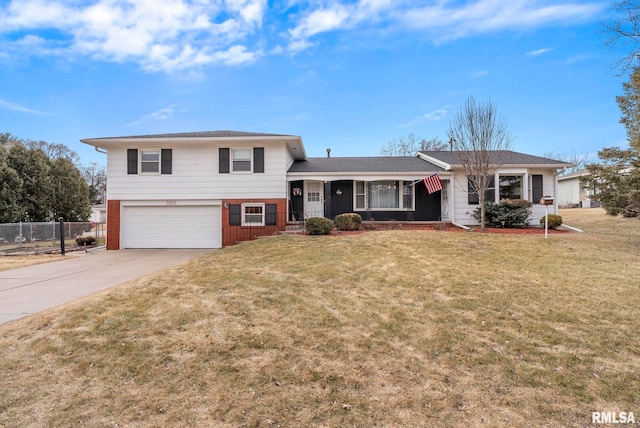 split level home featuring a front lawn and a garage