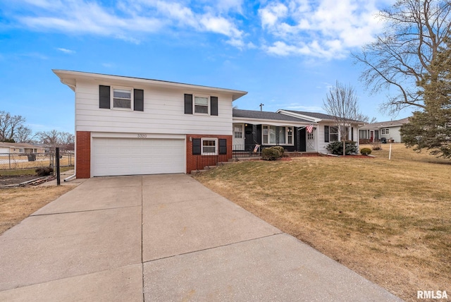 tri-level home with a front yard, a garage, and a porch