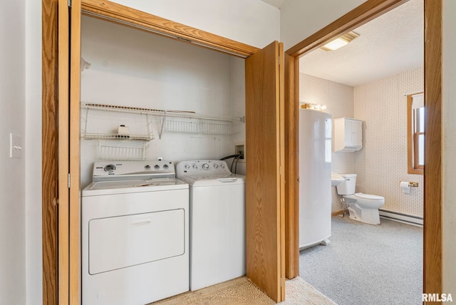 washroom with light carpet, water heater, and separate washer and dryer