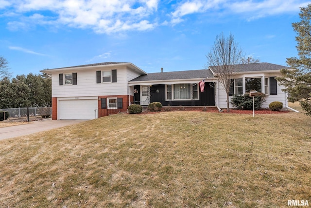 split level home with a front yard and a garage