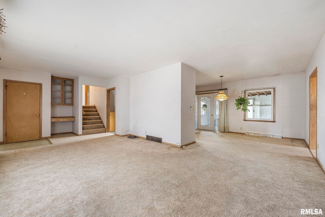 unfurnished living room with a baseboard radiator and light colored carpet