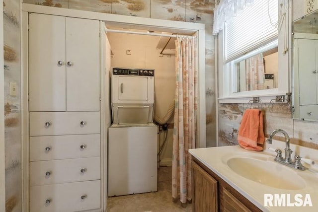 bathroom with stacked washer and dryer and vanity