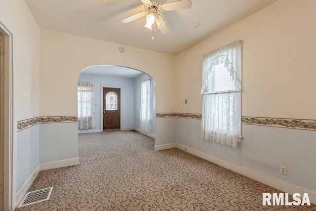 entrance foyer featuring light colored carpet and ceiling fan