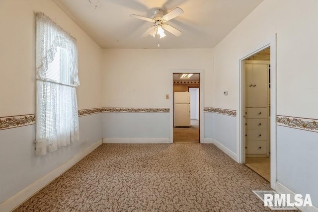 carpeted empty room with ceiling fan