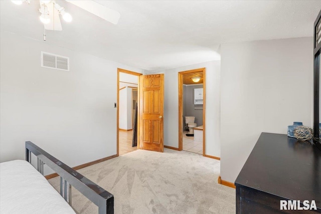 carpeted bedroom featuring ensuite bathroom