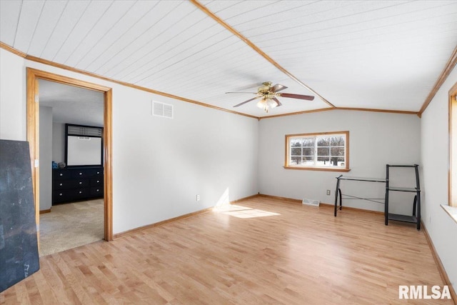 empty room with lofted ceiling, ornamental molding, ceiling fan, and light hardwood / wood-style flooring