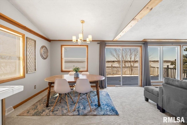 dining space featuring a notable chandelier, carpet flooring, lofted ceiling with beams, and a healthy amount of sunlight