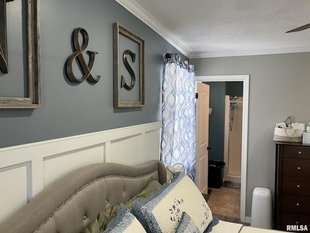 bedroom featuring crown molding, a spacious closet, and a textured ceiling