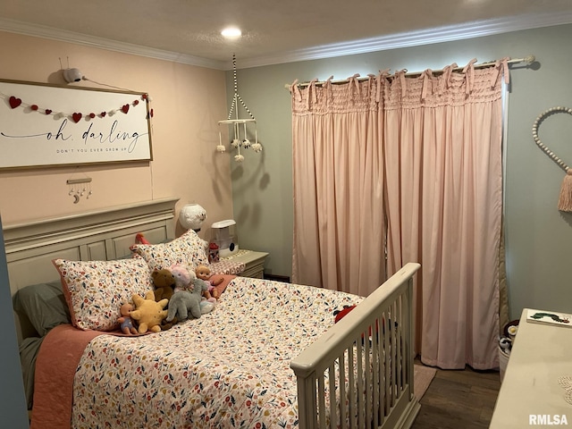 bedroom featuring dark hardwood / wood-style flooring and ornamental molding