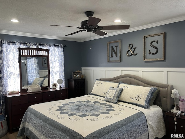 bedroom with ceiling fan, ornamental molding, and a textured ceiling