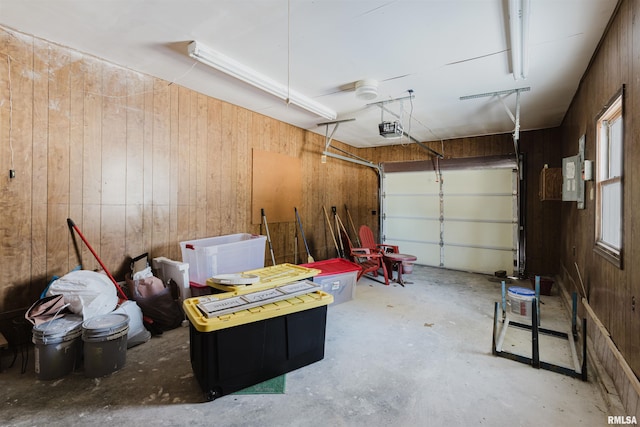 garage with wooden walls and a garage door opener