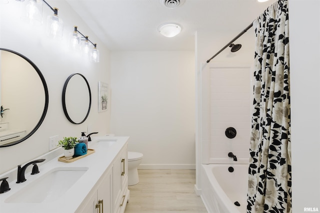 full bathroom with visible vents, toilet, shower / tub combo with curtain, wood finished floors, and a sink