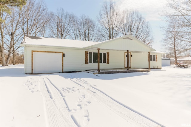 ranch-style house featuring an attached garage and covered porch