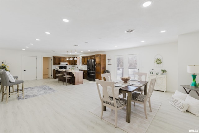 dining room featuring light wood-style floors, visible vents, and recessed lighting