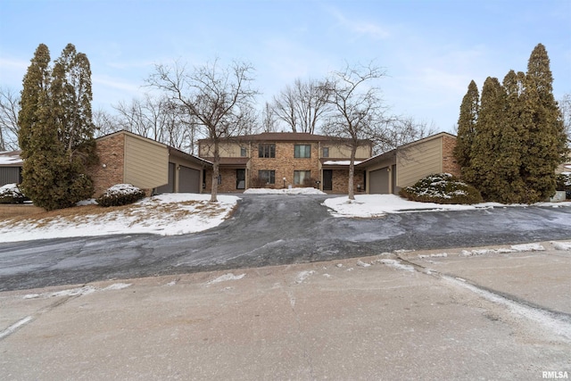 view of front of property with a garage and brick siding